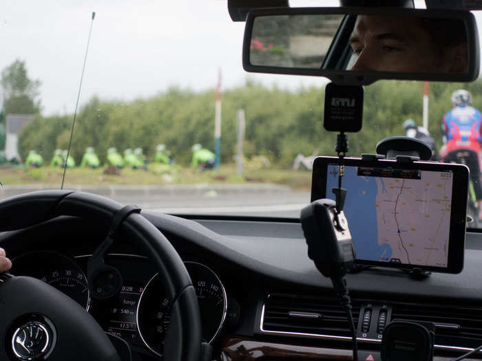 There is two-way communication between the riders and the sporting directors in the car via radios. There is also a map of the racecourse loaded for the guys in the car. On this day before the Tour