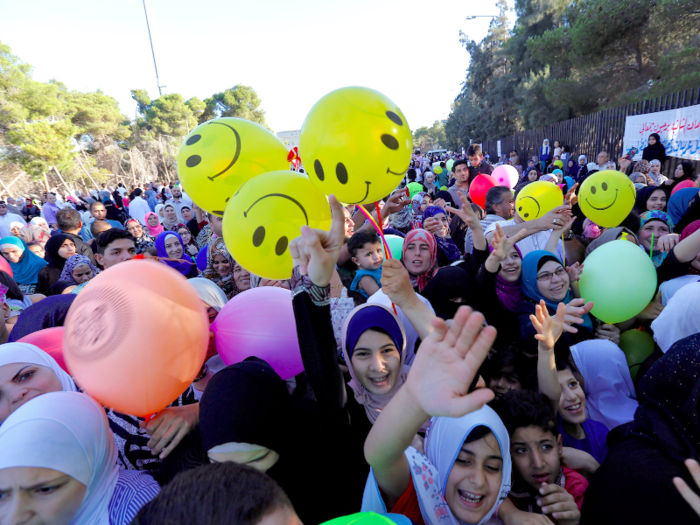 JORDAN: The street parties are huge and can attract thousands of celebrating Muslims. These children are racing to get balloons following the morning prayers in Amman, Jordan.