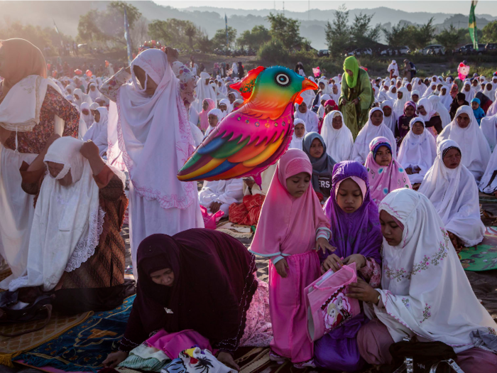 INDONESIA: Muslim women attend the celebrations on the "sea of sands" at Parangkusumo beach in Yogyakarta, Indonesia.