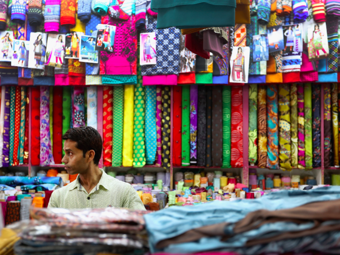 UNITED ARAB EMIRATES: A man arranges colourful fabrics at a store in Satwa ahead of Eid celebrations in Dubai.