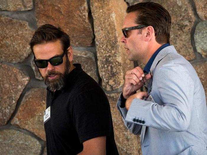 Brothers James and Lachlan Murdoch arrive together in dark shades.