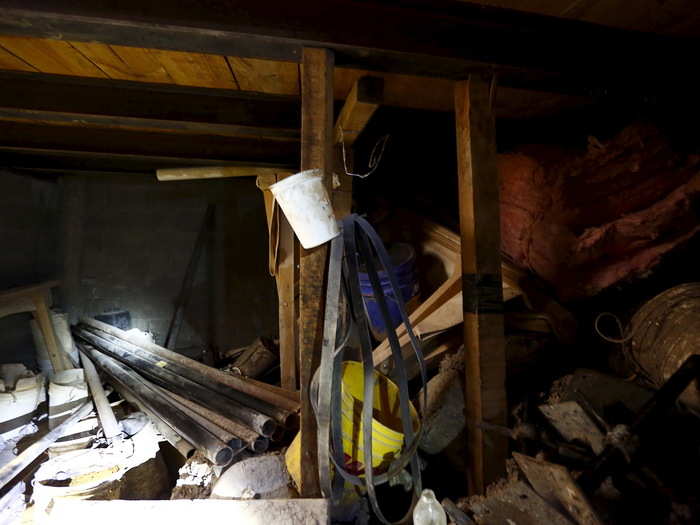 The end of the tunnel led to a basement of an abandoned home. The room was full of construction materials.