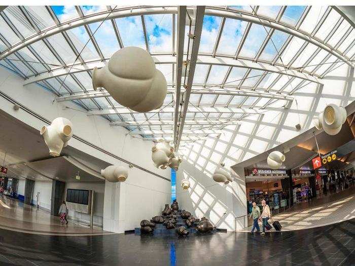 Sculptor Peter Shelton built "Clouds and Clunkers" out of plastic, stainless steel, and cast iron. It was placed in Seattle-Tacoma International Airport in 2006 and assembled on a set of bleachers, where passerby were encouraged to sit and relax among the clunkers.