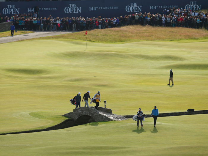 Pose for a photo on the Swilcan Bridge on the Old Course in St. Andrews. It