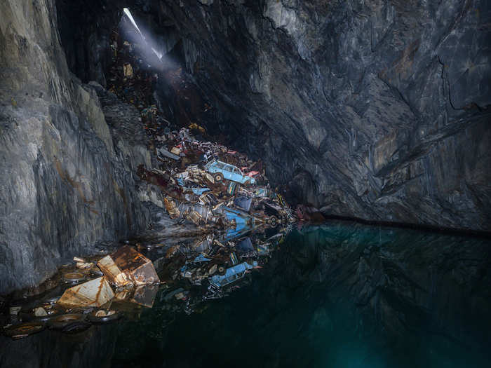 The photographer has an eye for hidden spots that most people would miss — like this cave crammed with old cars in England...