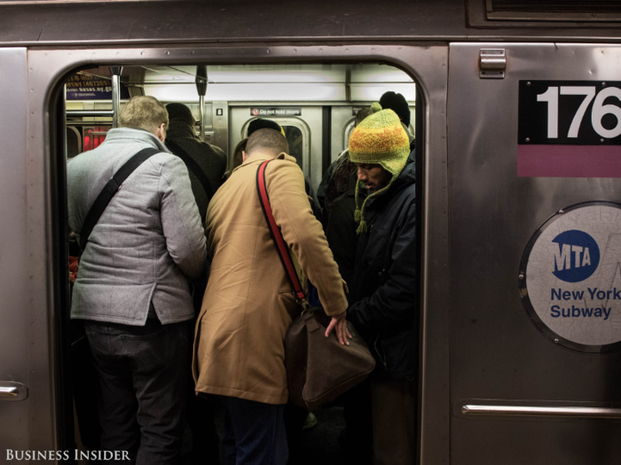 Let the people getting off of the train exit before you get on.