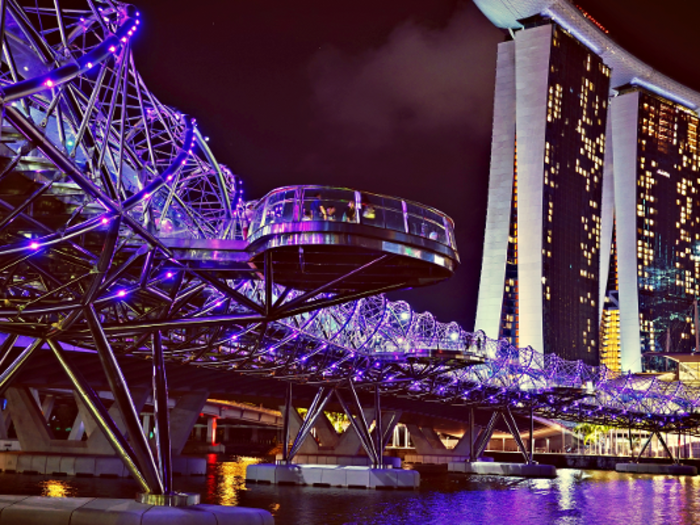 The twisty Helix Bridge in Singapore lights up at night, with each color representing different DNA strands.