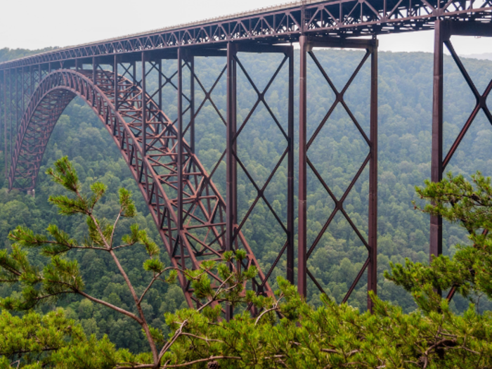 The New River Gorge Bridge in West Virginia is nestled in a particularly stunning landscape. It especially looks beautiful when surrounded by fall foliage.