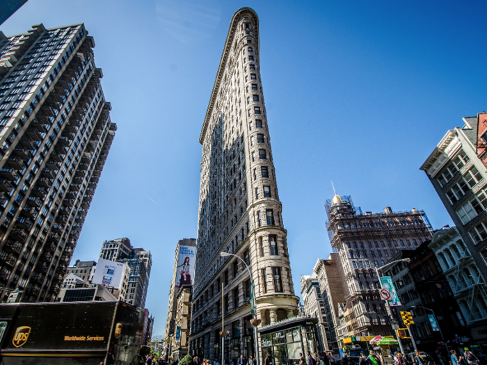 FLATIRON BUILDING: This triangular landmark has an entire neighborhood named after it. When it was first built, legend holds that men would linger around it to try to glimpse the winds around the oddly shaped building lift a woman