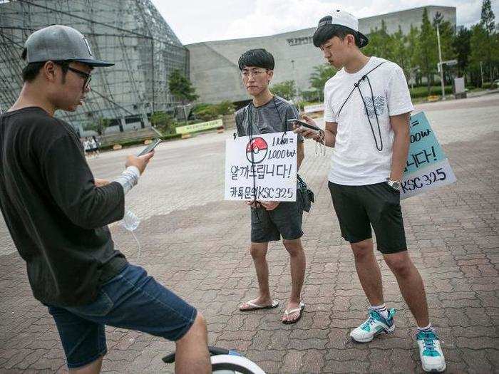 Here, two people in Sokcho offer their "Pokémon GO"-related service, where customers can pay them to walk around and hatch their eggs.