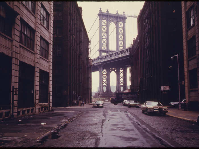 Manhattan Bridge Tower in Brooklyn, framed through nearby buildings.