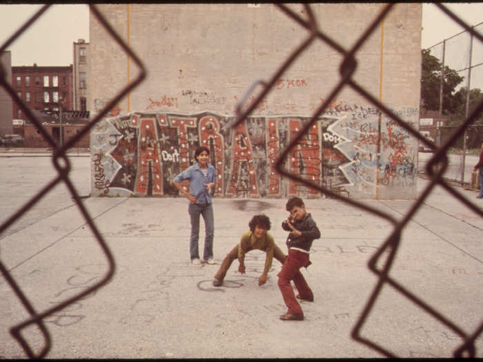 Three boys and "A Train" graffiti in Brooklyn