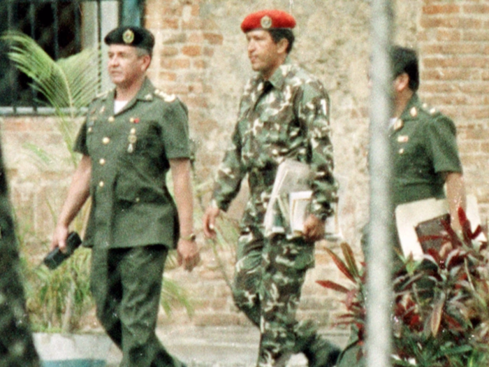 Then Lt. Col. Hugo Chavez, center, walking with military intelligence officers after being arrested for trying to overthrow Venezuela