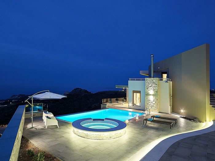 "Blue Key Villa" is a three-story, terraced residence perched above the sea on the island of Crete in Greece. With the beach only a few minutes away, and access to the cute fishing village of Agia Pelagia at just a mile