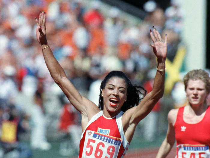 American sprinter Florence Delorez Griffith Joyner (a.k.a. Flo-Jo) crosses the finish line first during the 100 meter final at the 1988 Games in Seoul.