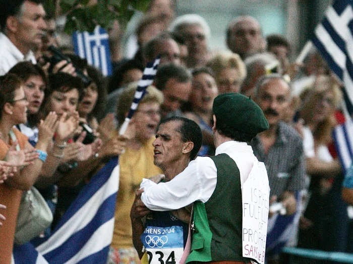 A spectator grabs Brazilian runner Vanderlei de Lima while he was leading the Marathon at the Athens Games.