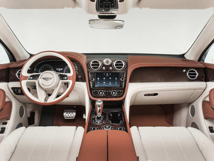 Handcrafted wood and leather add to the car