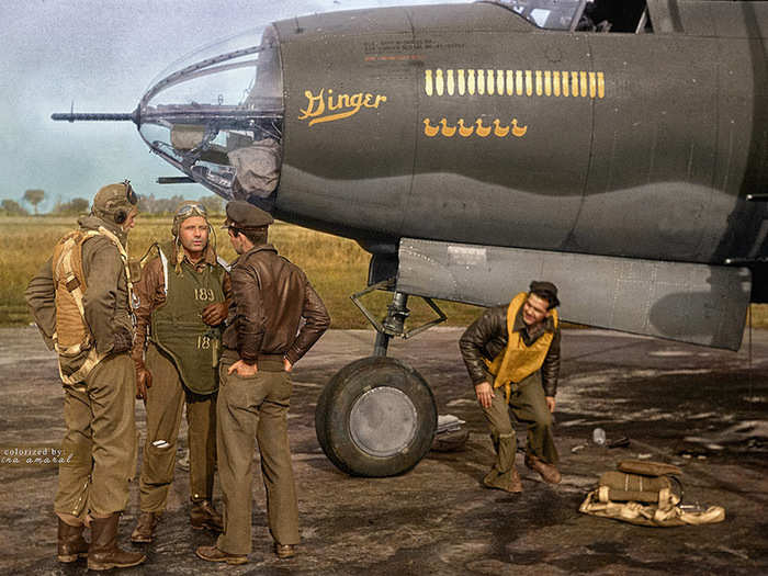 Crew members stand next to a B-26 Marauder, a twin-engined medium bomber used in Western Europe during World War 2.