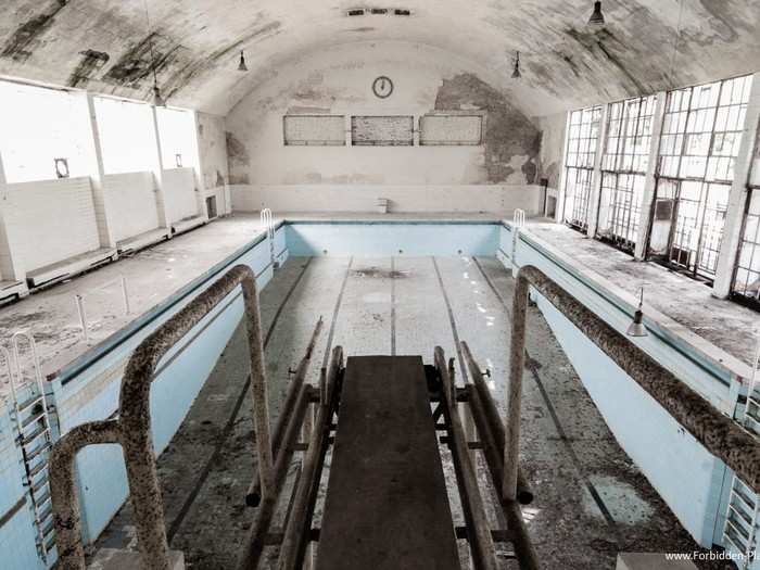 A indoor pool allowed swimmers and divers to practice and relax before competition. It now sits empty and unused.