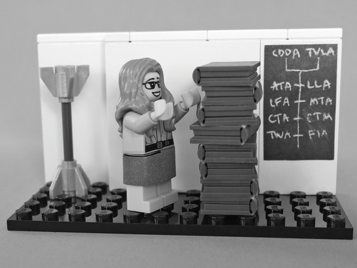 In the 1960s, Hamilton developed the on-board flight software for the Apollo missions to the moon. Her Lego model is a recreation of a famous photo in which Hamilton is standing next a stack of books containing the software.