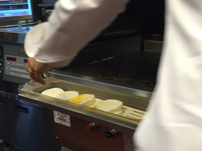 They are scooped into a warming bin, and moved to a table for sandwich assembly.