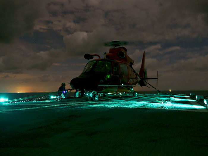 An Air Station Corpus Christi MH-65 Dolphin helicopter lands on Coast Guard Cutter Dauntless November 14, 2013.