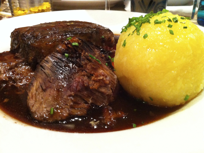 Sauerbraten is best described as a German pot roast made with beef, vinegar, and plenty of spices and seasonings.