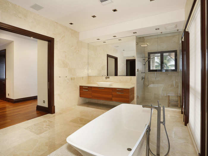 These bathrooms are large, with sit-down showers and stylish tubs.