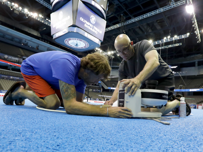 Before the athletic events begin, Bello sets up his Canon camera inside a waterproof enclosure.