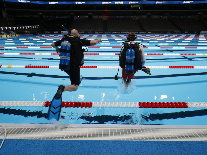 Then he dives into the pool (in full scuba gear!) to set it up at just the right angle.