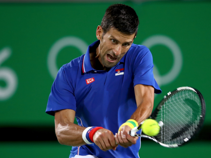 Novak Djokovic of Serbia plays a backhand in a singles match against Juan Martin Del Potro of Argentina.