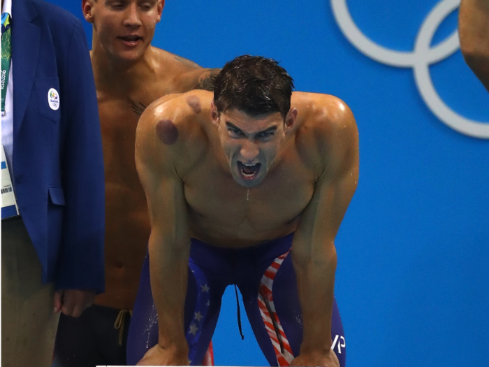 American swimmer Michael Phelps — the most decorated Olympian of all time — aggressively cheers his teammates in the 4x100 freestyle relay.