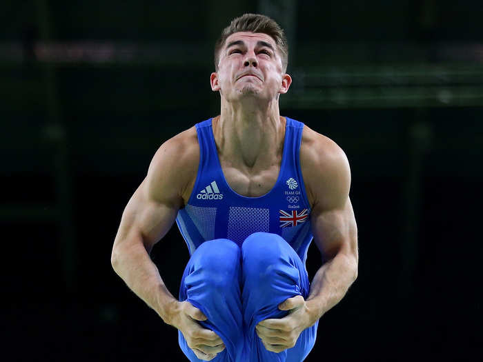 British gymnast Max Whitlock of Great Britain flies high above the parallel bars.