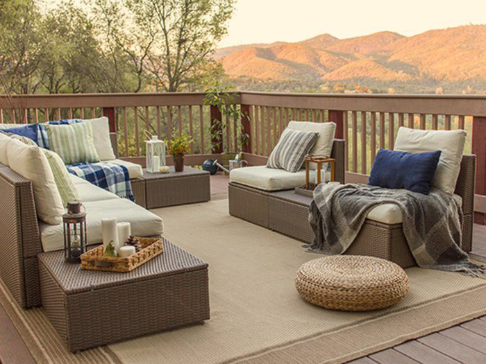 A large outdoor rug and some furniture completely transformed the space. The lounge chairs, throws, and pillows were purchased from IKEA and Target, proving no renovation has to be expensive.