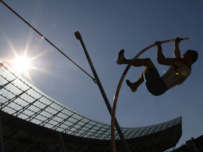 The "Fosbury Flop" is a technique that pole vaulters use to hurl themselves high into the air. They arch their bodies over the bar so that their center of mass actually passes inches beneath the bar, which requires less energy.