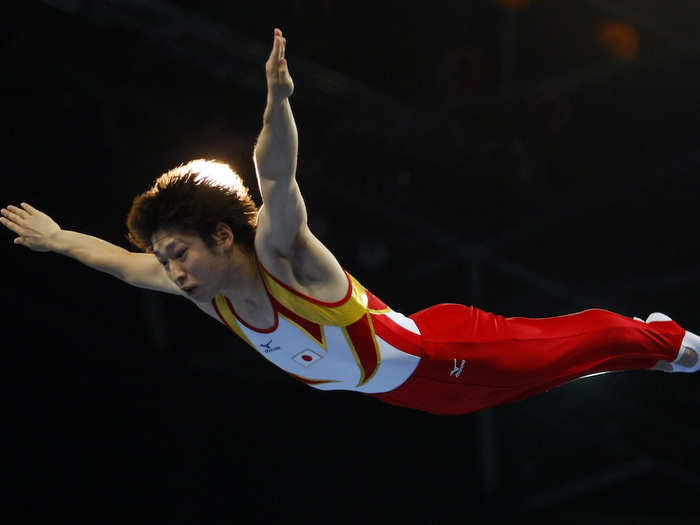 As the springs on the trampoline are stretched, they exhibit an equal and opposite force in order to snap back into equilibrium, which propels the athletes into the air.