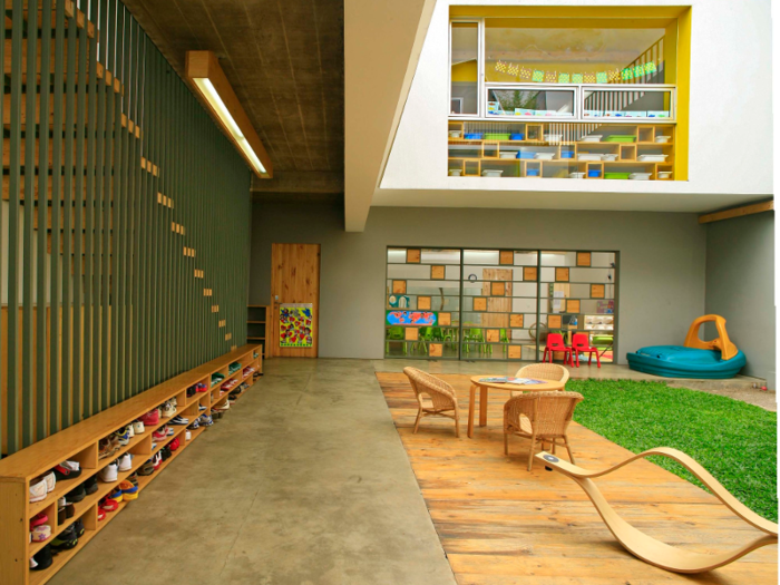 Shining Stars Kindergarten, located in the Indonesian capital of Jakarta, contains small courtyards to promote the flow of natural light and natural-wood play spaces to make kids feel like they