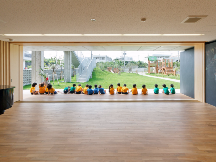 In Miyakojima, Japan, the equally spacious Hanazono Kindergarten transitions seamlessly from finished wood to well-manicured lawns through sliding doors. The school was built to resist typhoons and allow for easy ventilation.