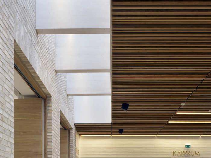 The reception area is lined with stone walls and wood ceilings.