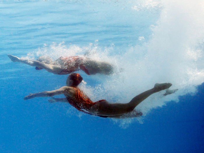 Their embellished bathing suits add flare to the routines.