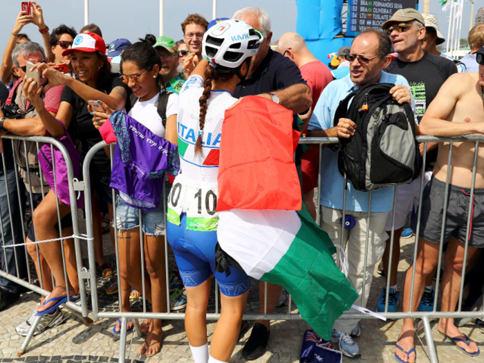 Elena Cecchini, of Italy, takes a moment to hug family members before beginning the women