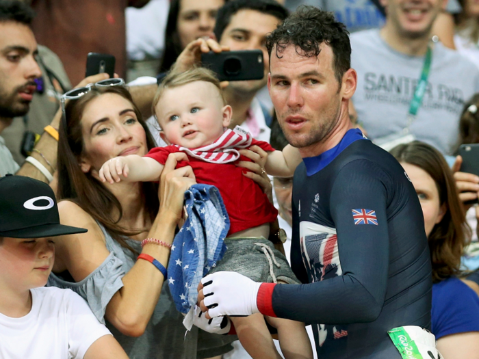 Cyclist Mark Cavendish, of Great Britain, greets his wife and son at the men