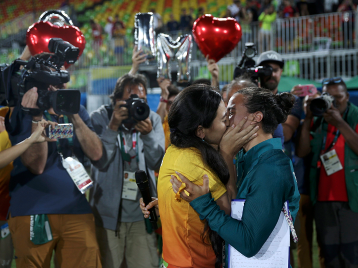 Brazilian rugby player Isadora Cerullo hugs fiancée Marjorie after accepting her marriage proposal.