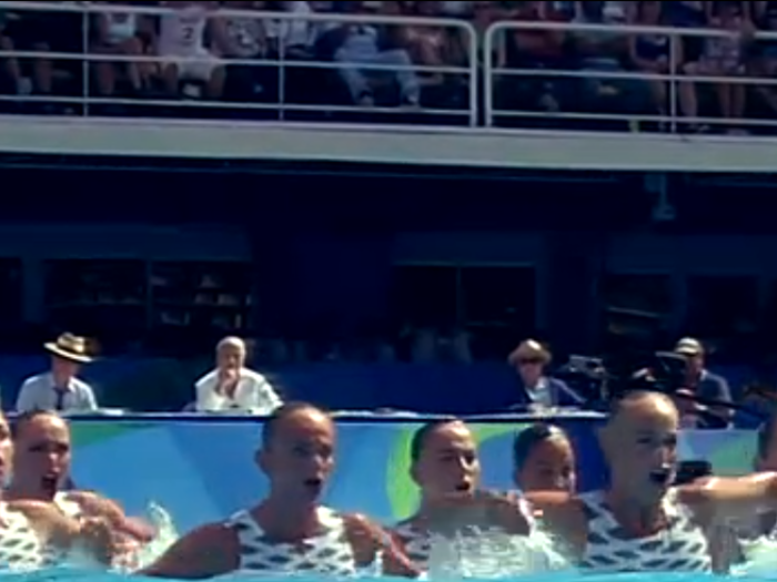 Swimmers from Ukraine emote during their routine.