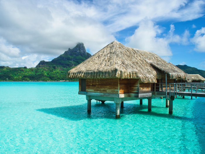 Stay in a luxury bungalow on the stunningly blue waters of Bora Bora in French Polynesia.
