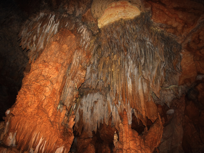 Wade through the Actun Tunichil Muknal Cave in Belize. The cave is full of ancient artifacts, and there