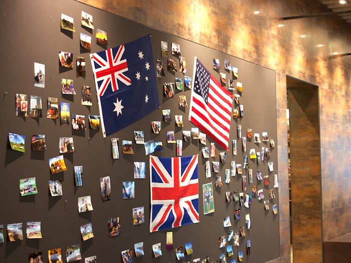 A bulletin board displays the flags of the three countries where Tough Mudder has offices (the US, the UK, and Australia). Employees can take part in the challenge at no cost.