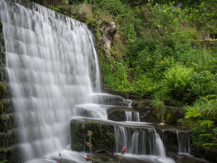 7. Watch the water of Lumsdale Falls pour over rocks into Bentley Brook in the woods near Matlock, Derbyshire.