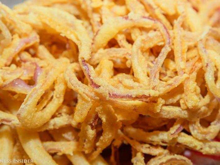 The onion rings are a tour de force: thinly sliced red onion strings, fried to a golden, greasy crisp. Sure they