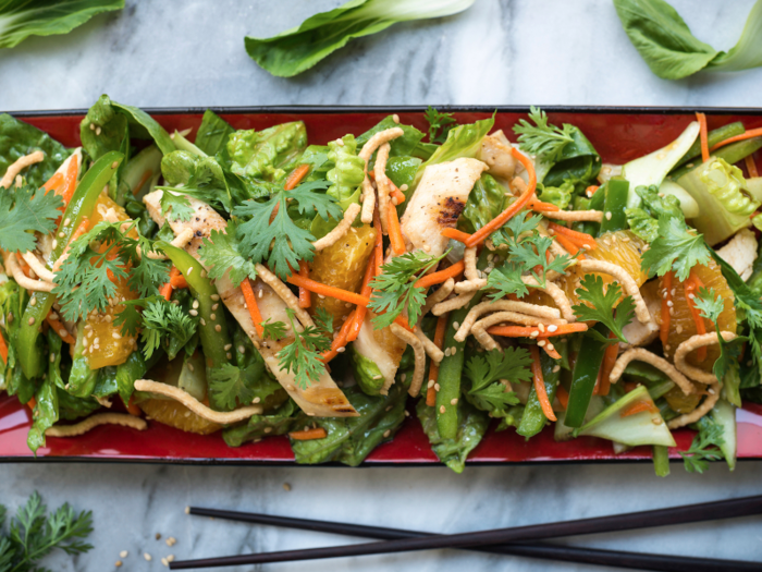 California: A blend of American and Chinese cuisine, Chinese chicken salad usually contains chicken, romaine lettuce, cabbage, crispy rice noodles, mandarin orange slices, as well as sliced almonds or cashews.